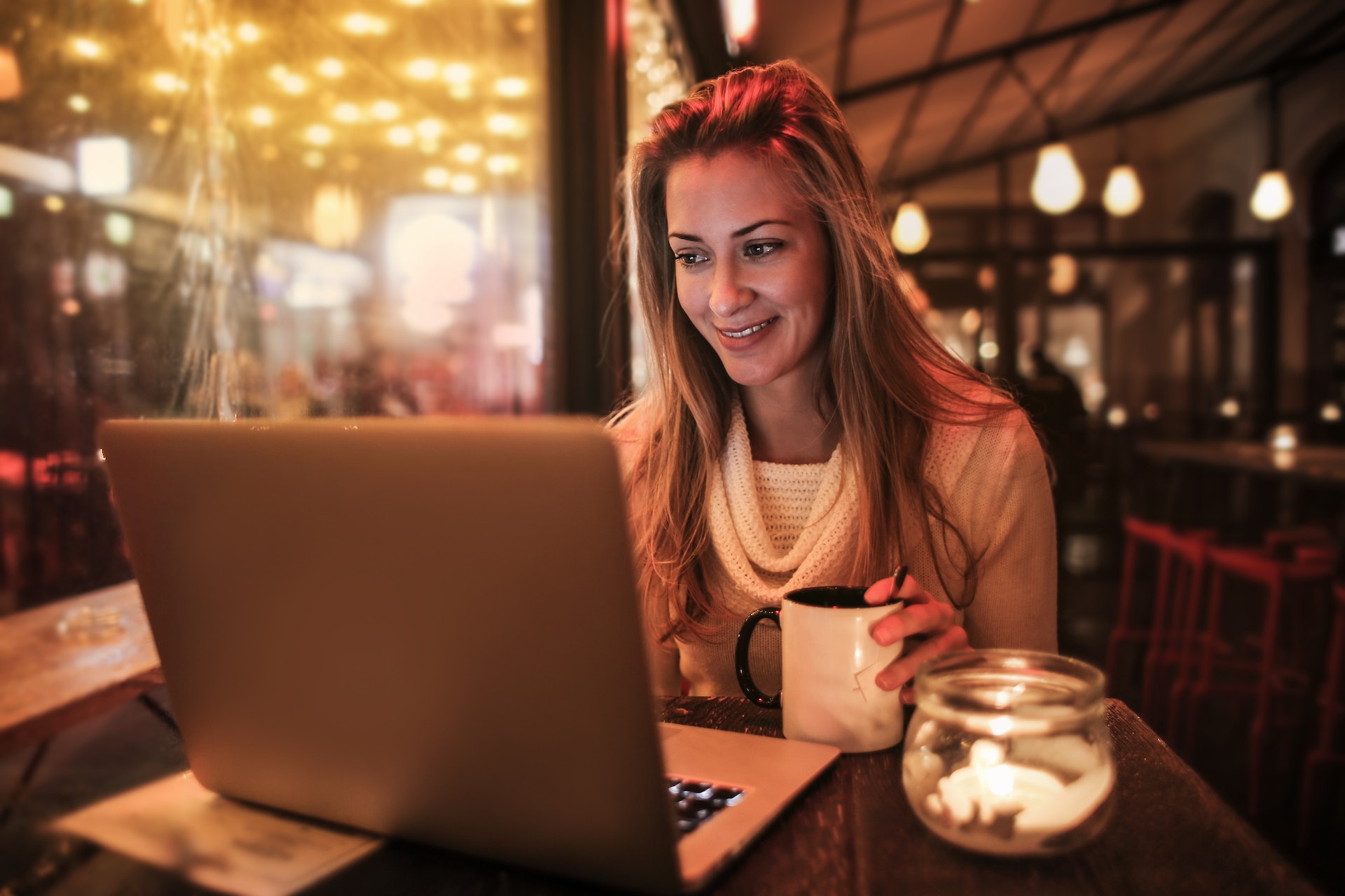 woman around computer with tea cup