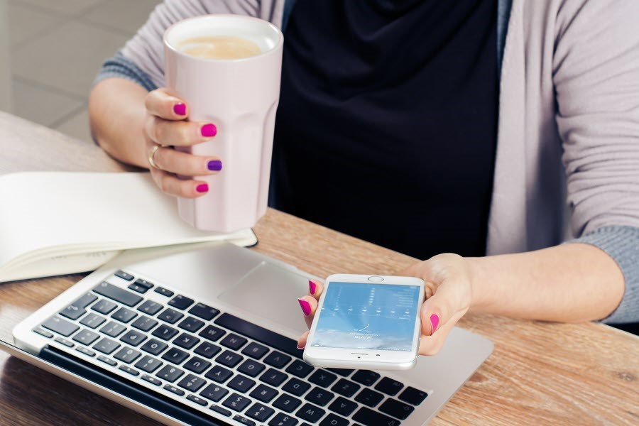 lady with cellphone, coffee and laptop