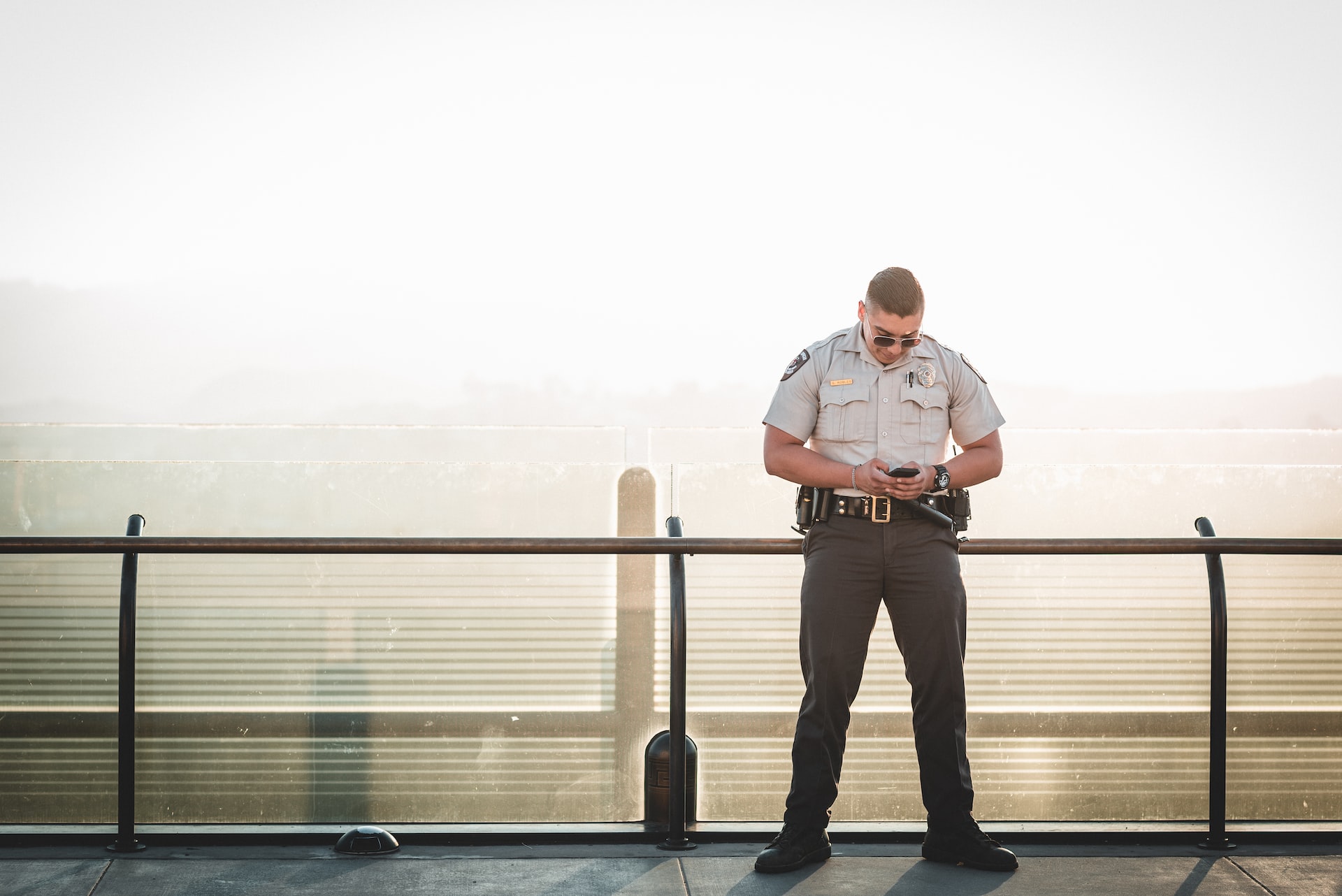 police or security guard on his phone