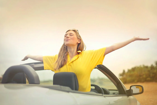 Lady in Yellow top in Convertible Car