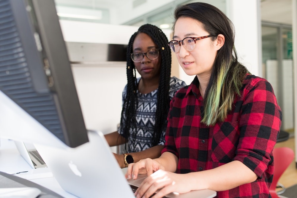 Ladies in glasses working around computer