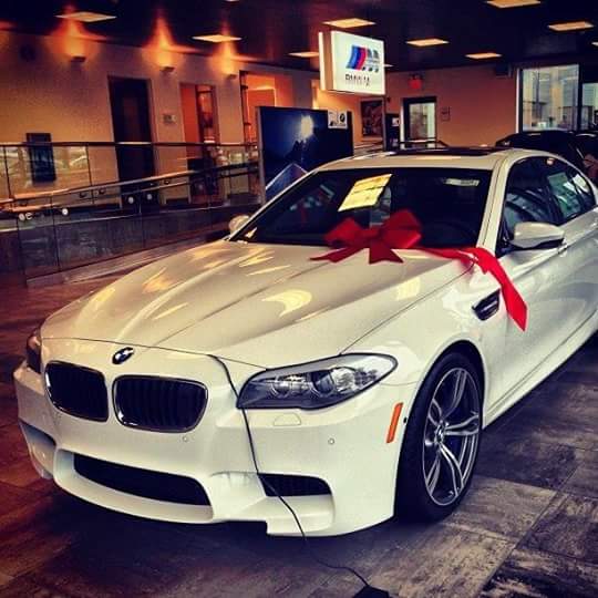 White BMW with red ribbon